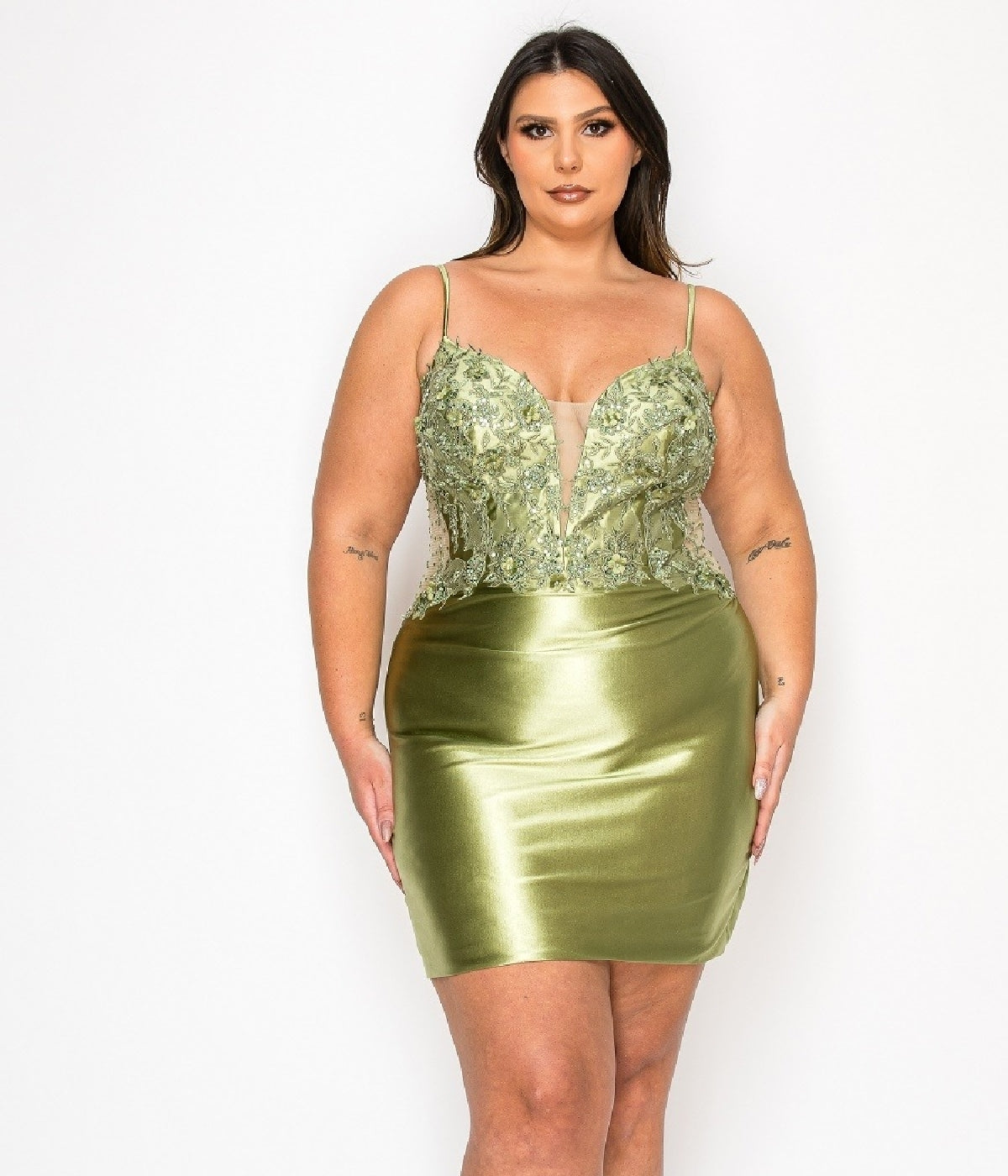 A woman models the Poly USA W1176, a plus-size short party dress with a green satin finish, beaded floral-embroidered bodice, and thin straps, against a plain white background.